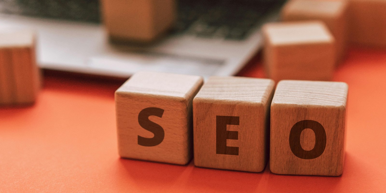SEO blocks beside a laptop for Google search visibility