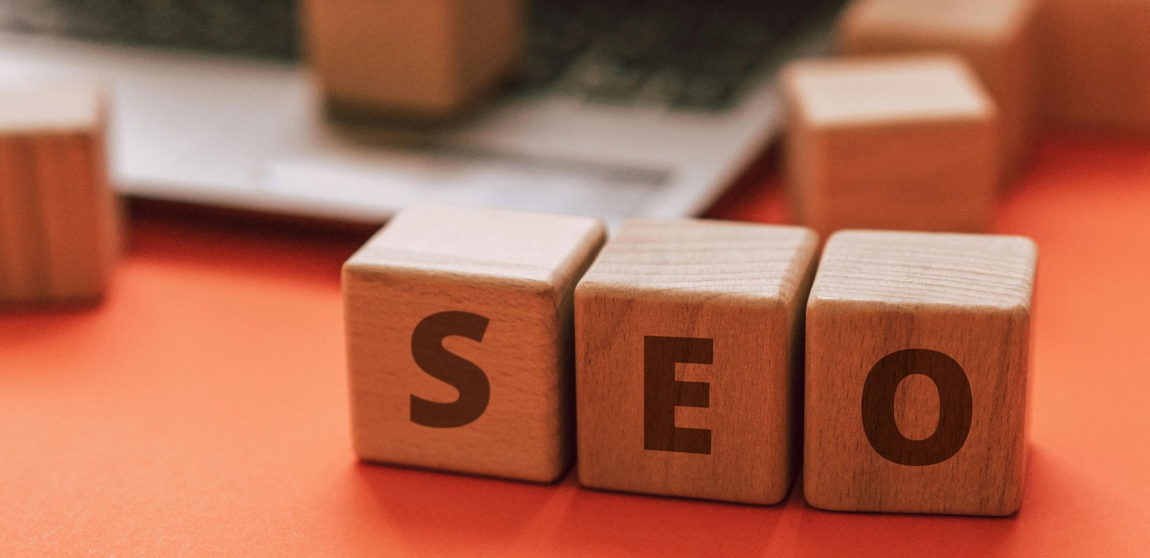 SEO blocks beside a laptop for Google search visibility