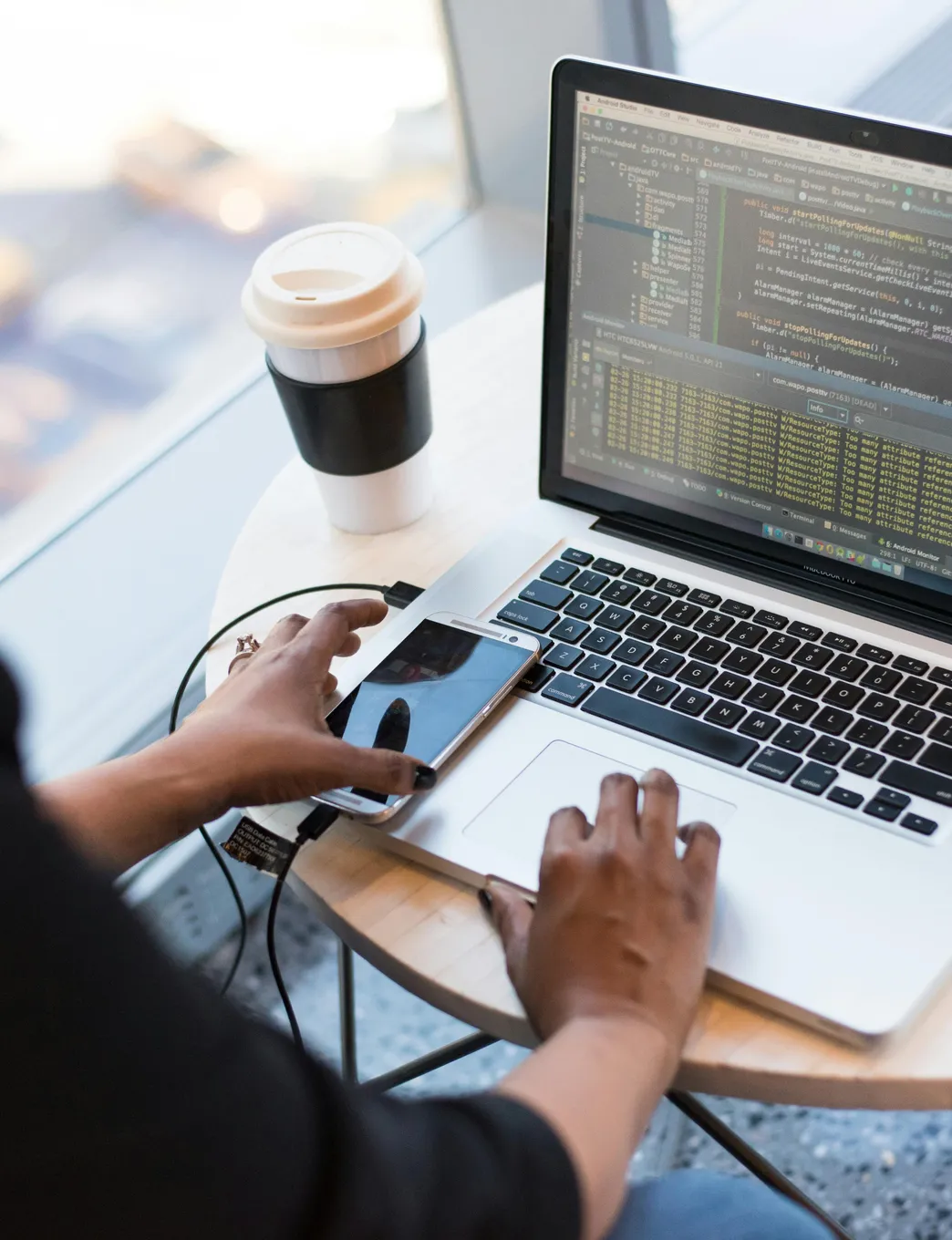 web developer writing custom code on laptop