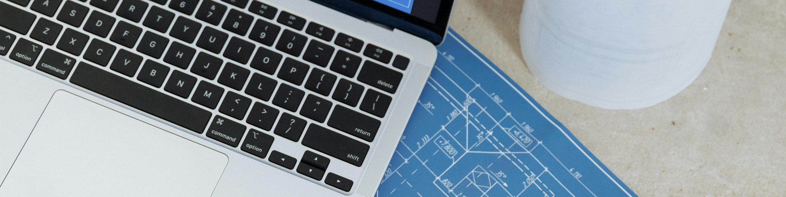 laptop on blueprints representing website planning and strategy